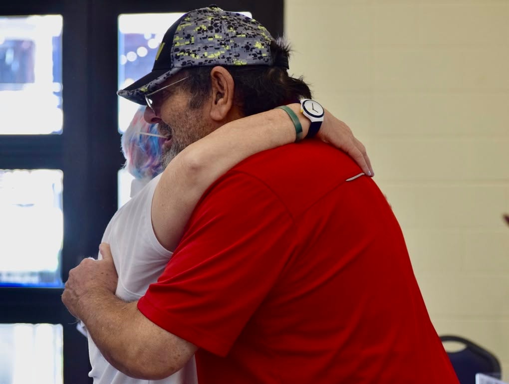 Two men in warm embrace