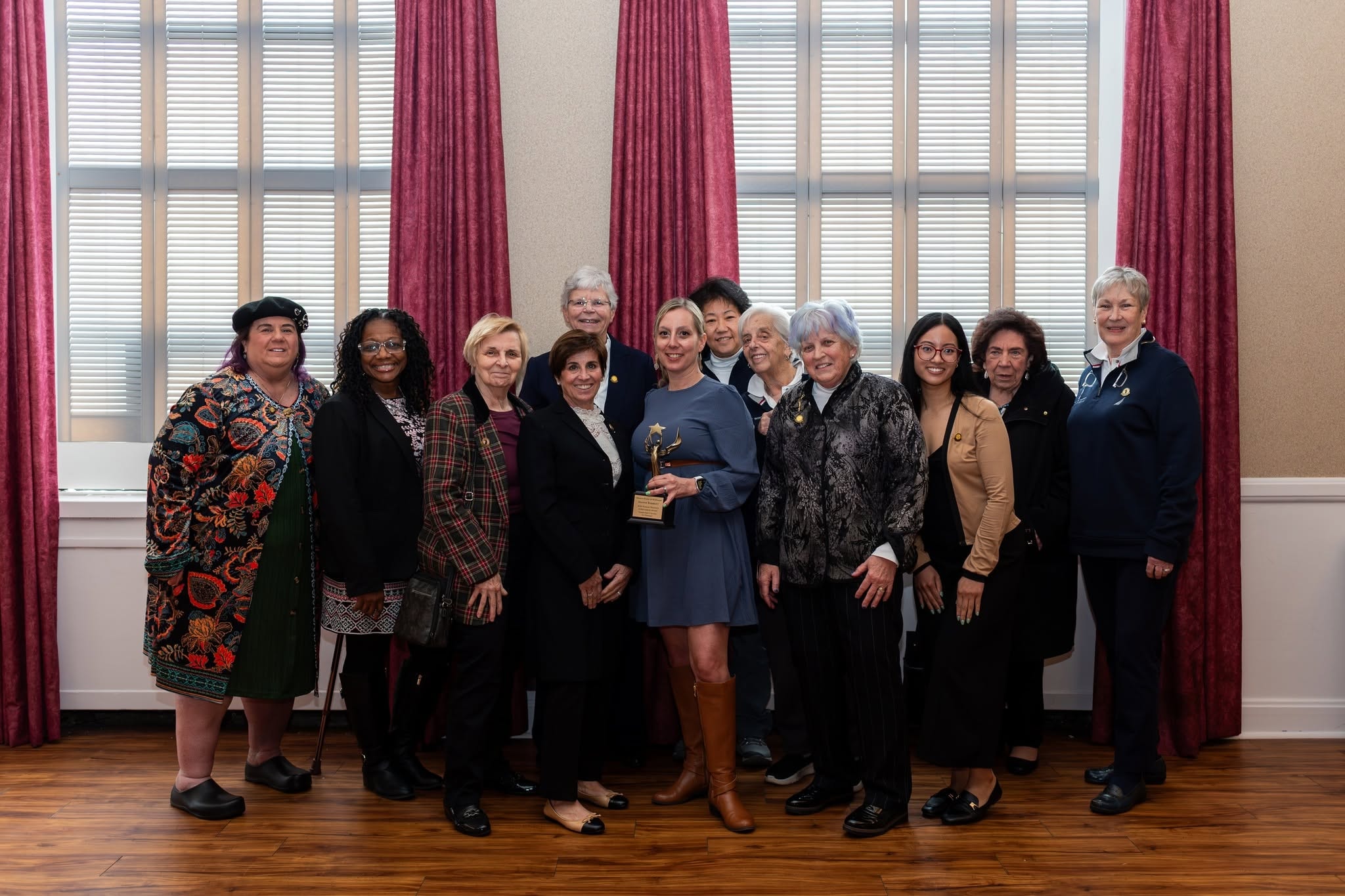 Group of women holding award at formal event