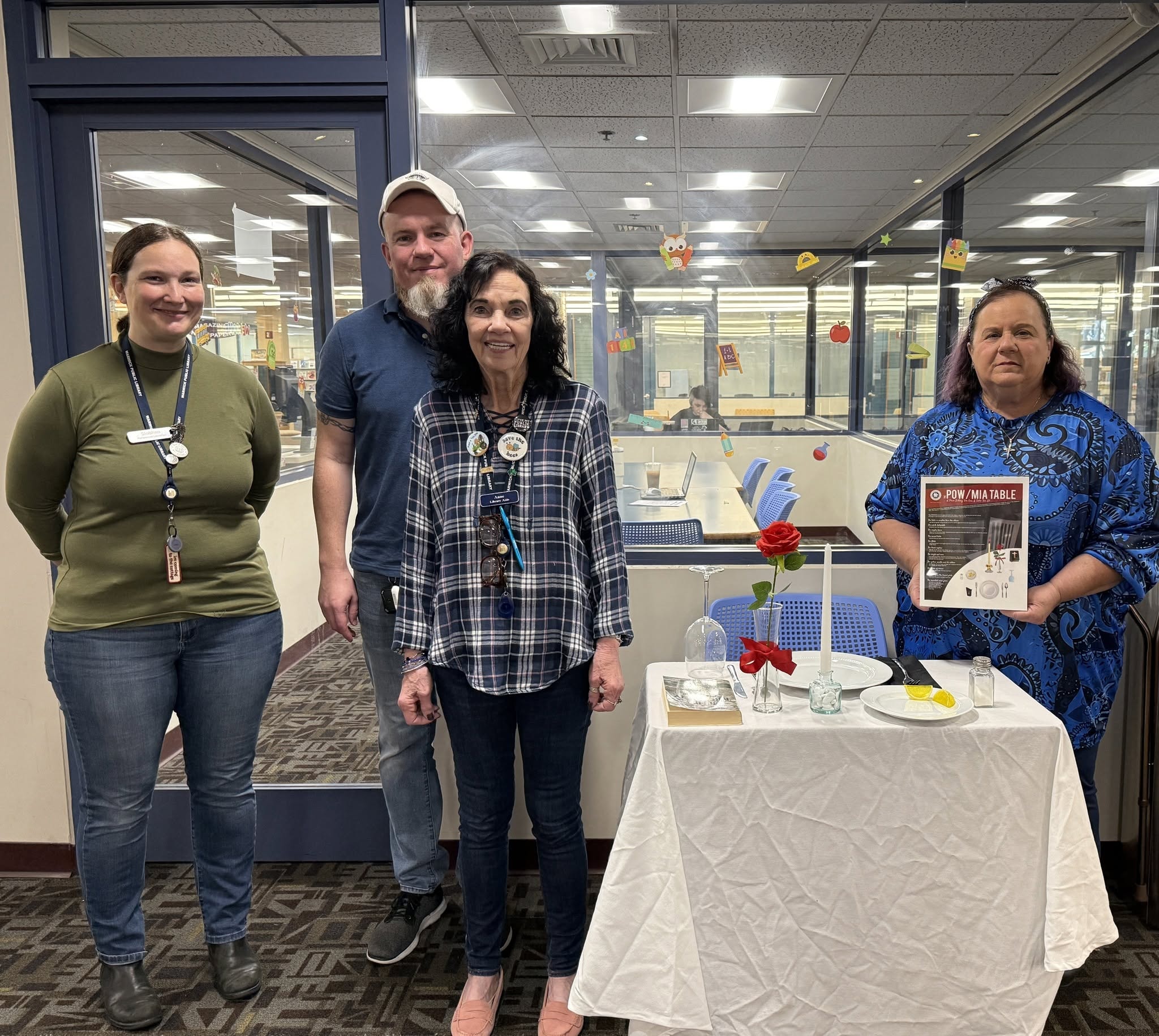 Four people posing at workplace event