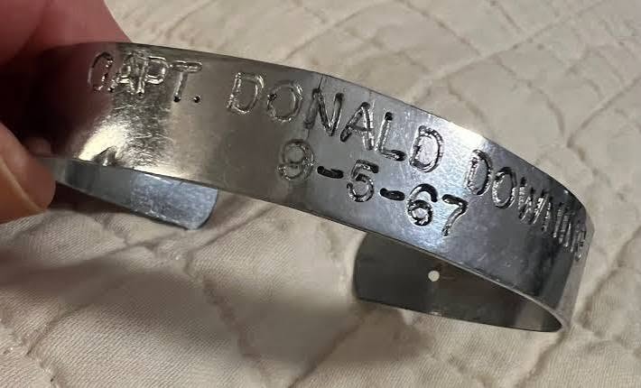 Engraved metal bracelet with tribute text