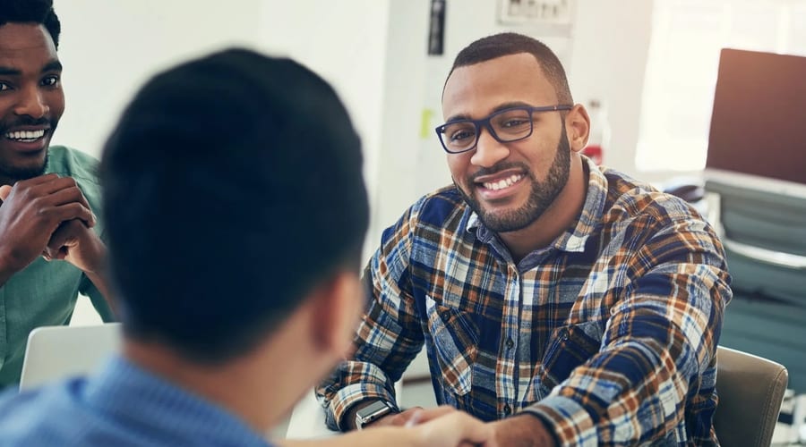 Employer and veteran shaking hands at a hiring interview